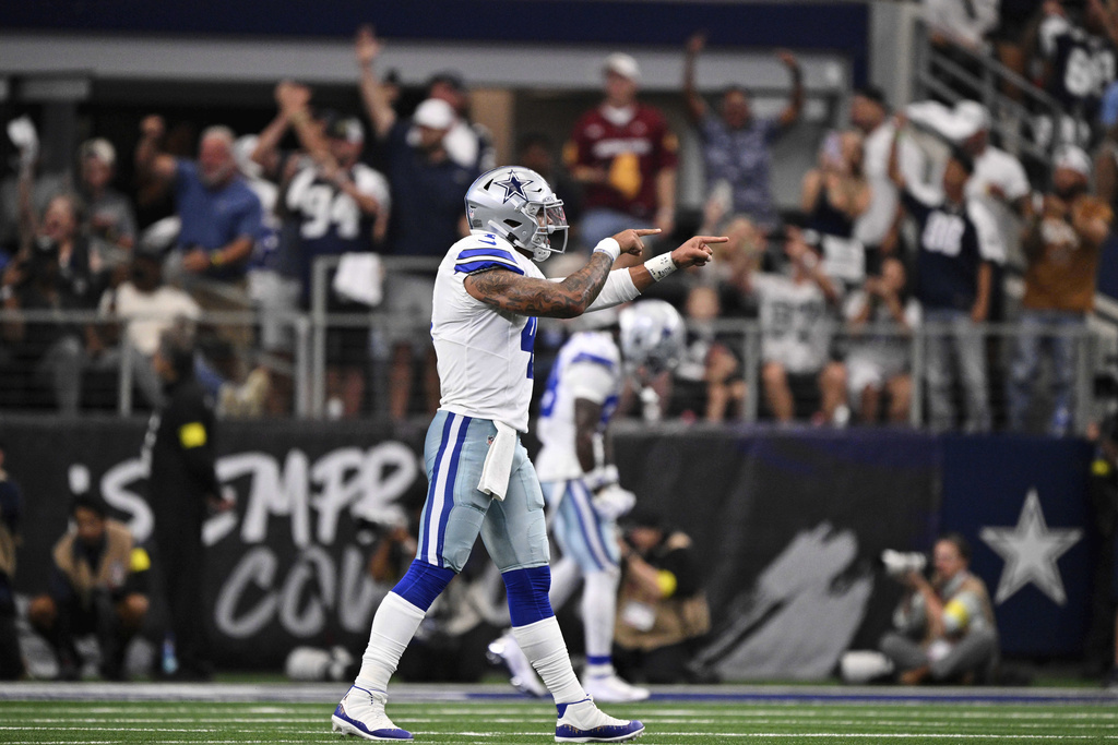 Dallas Cowboys quarterback Dak Prescott (4) celebrates a touchdown late in the second half of an NFL football game against the New York Giants Sunday, Sept. 14, 2025, in Arlington, Texas. (AP Photo/Jerome Miron)