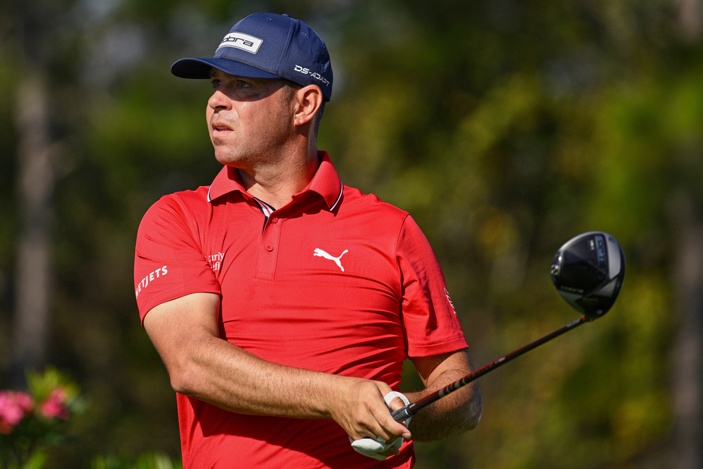 FILE - Gary Woodland looks on after hitting his tee shot on the second hole during the final round of the PNC Championship golf tournament, Dec. 21, 2025, in Orlando, Fla. (AP Photo/Phelan M. Ebenhack, File)