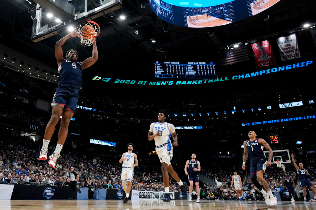 FILE - UConn forward Tarris Reed Jr. (5) dunks against Duke during the second half in the Elite Eight of the NCAA college basketball tournament on March 29, 2026, in Washington. (AP Photo/Stephanie Scarbrough, File)