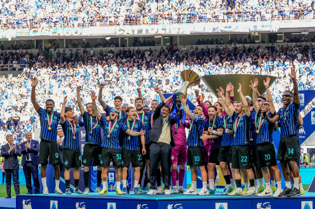 Inter Milan players celebrate with the Italian Serie A soccer championship trophy after it was presented to them at the end of their final-round match against Hellas Verona in Milan, Italy, Sunday, May 17, 2026. (AP Photo/Luca Bruno)
