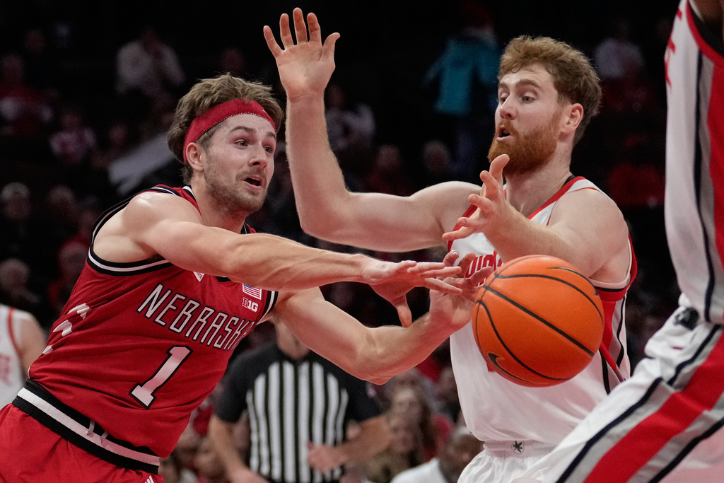 Nebraska guard Sam Hoiberg (1) passes in front of Ohio State forward Brandon Noel, right, in the first half of an NCAA college basketball game Monday, Jan. 5, 2026, in Columbus, Ohio. (AP Photo/Sue Ogrocki)