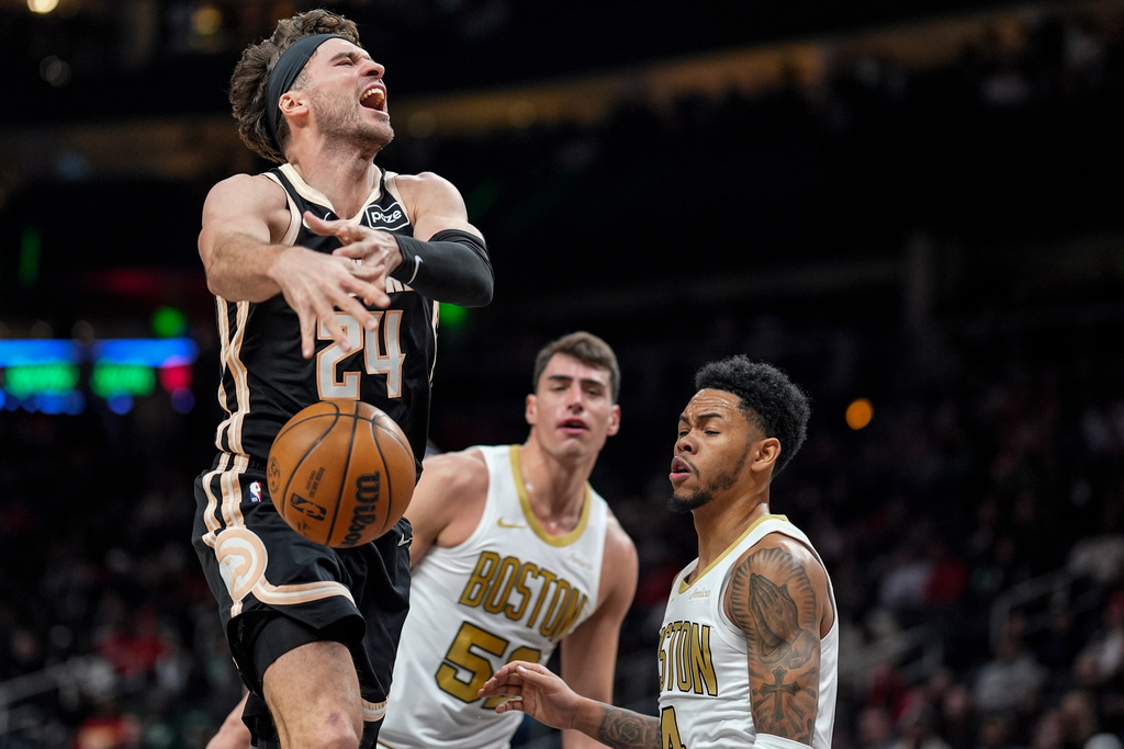 Atlanta Hawks forward Corey Kispert (24) shoots against Boston Celtics guard Anfernee Simons (4) during the first half of an NBA basketball game, Saturday, Jan. 17, 2026, in Atlanta. (AP Photo/Mike Stewart)