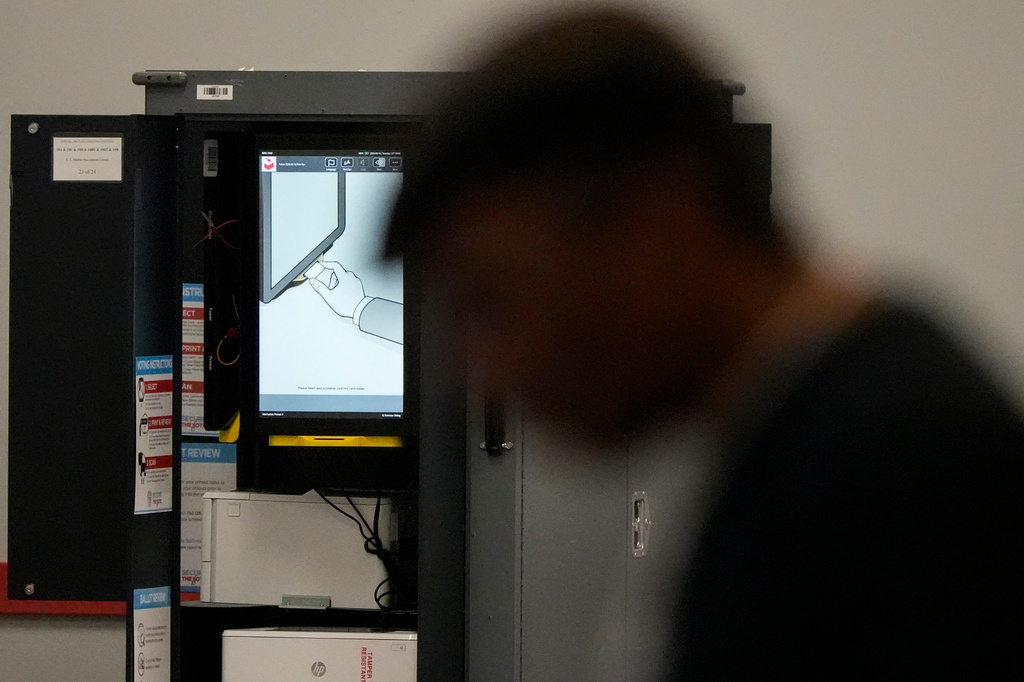 A voting machine is seen as people vote in a runoff election at the C.T. Martin Recreation Center, Tuesday, June 16, 2026, in Atlanta. (AP Photo/Mike Stewart)