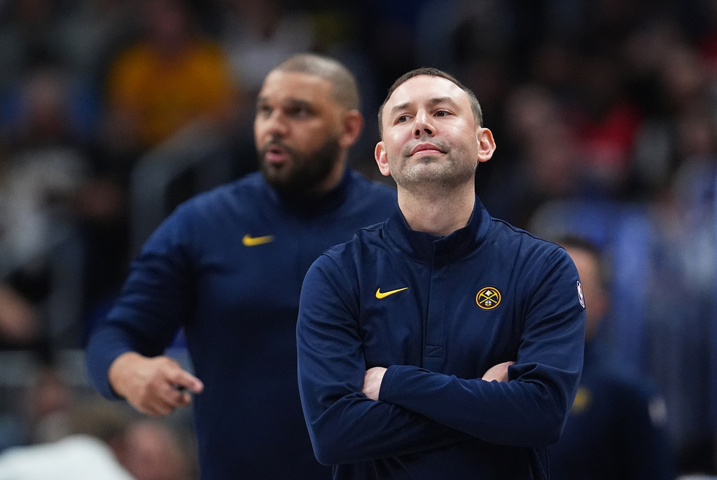 Denver Nuggets head coach David Adelman, front, looks on with assistant coach Jared Dudley, bacl, in the first half of an NBA basketball game against the New York Knicks, Friday, March 6, 2026, in Denver. (AP Photo/David Zalubowski)