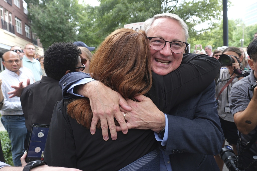Dr. Daniel Jernigan, leader of the agency's work on emerging infectious diseases hugs his friend as workers and supporters rally for departing scientific leaders at the Centers for Disease Control and Prevention outside the CDC headquarters, Thursday, Aug. 28, 2025, in Atlanta. (AP Photo/Ben Gray)