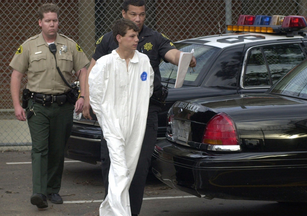 FILE - Santana High School freshman Charles "Andy" Williams is taken by San Diego Sheriff Deputies to Juvenile Hall in San Diego, Calif., March 5, 2001. (Charlie Neuman/The San Diego Union-Tribune via AP)