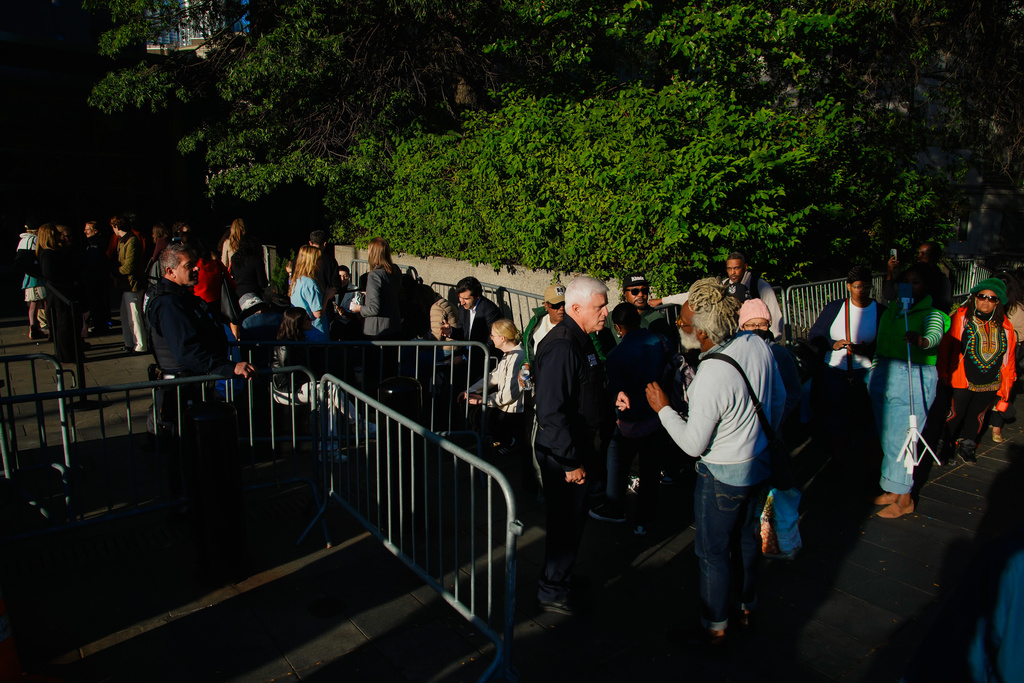 People wait outside to enter Manhattan federal court for the sentencing of Sean "Diddy" Combs in New York, Friday, Oct. 3, 2025. (AP Photo/Eduardo Munoz Alvarez)