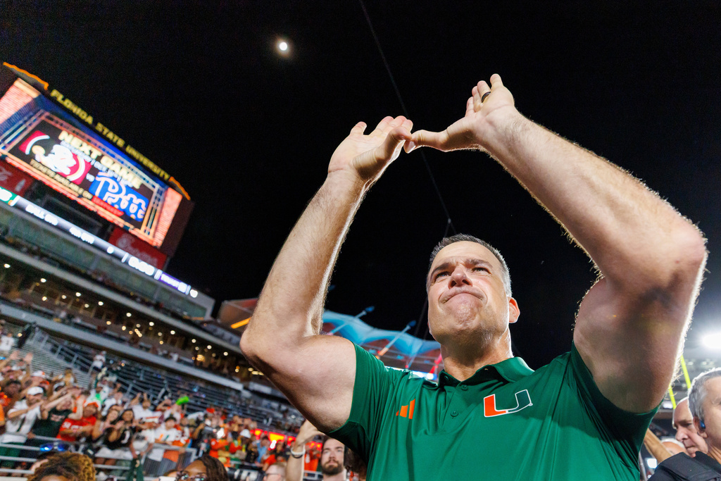 Miami head coach Mario Cristobal celebrates defeating Florida State in a NCAA college football game, Saturday, Oct. 4, 2025, in Tallahassee, Fla. (AP Photo/Colin Hackley)