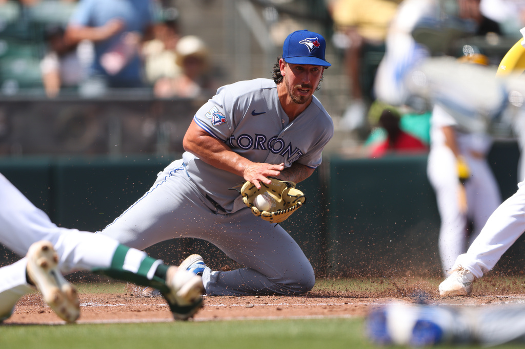 Toronto Blue Jays pitcher Michael Lorenzen, fields the ball after a wild pitch resulting in a run for the Athletics during the fourth inning of a baseball game Wednesday, Sept. 9, 2026, in West Sacramento, Calif. (AP Photo/Scott Marshall)