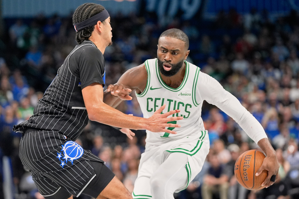 Boston Celtics forward Jaylen Brown, right, moves to get past Orlando Magic guard Anthony Black during the first half of an NBA Cup basketball game, Friday, Nov. 7, 2025, in Orlando, Fla. (AP Photo/John Raoux)