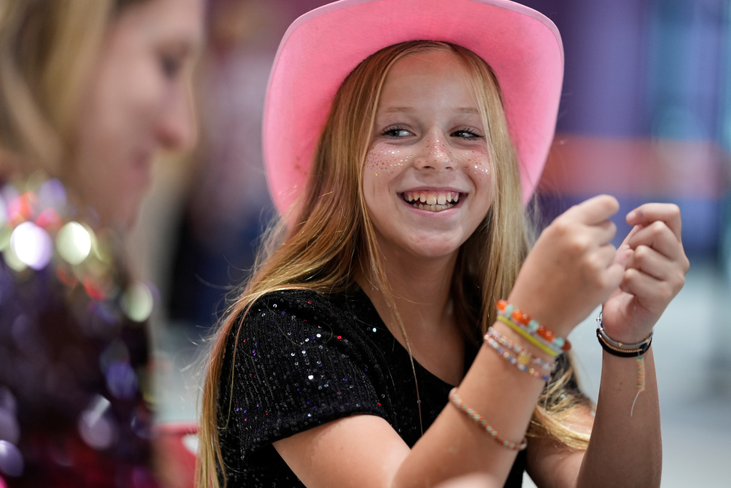 Hazel Gilbert, 10, builds a friendship bracelet during a release party for Taylor Swift's new album, "The Life of a Showgirl," at a movie theater Friday, Oct. 3, 2025, in Nashville, Tenn. (AP Photo/George Walker IV)