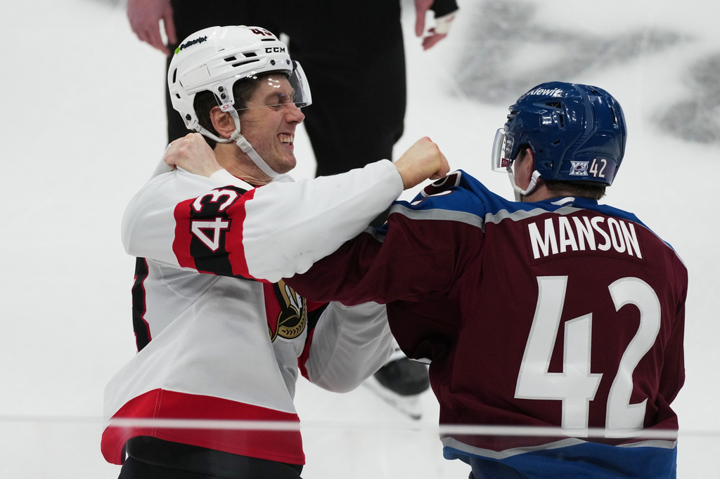 Ottawa Senators defenseman Tyler Kleven (43) throws a punch at Colorado Avalanche defenseman Josh Manson (42) in the first period of an NHL hockey game Thursday, Jan. 8, 2026, in Denver. (AP Photo/David Zalubowski)