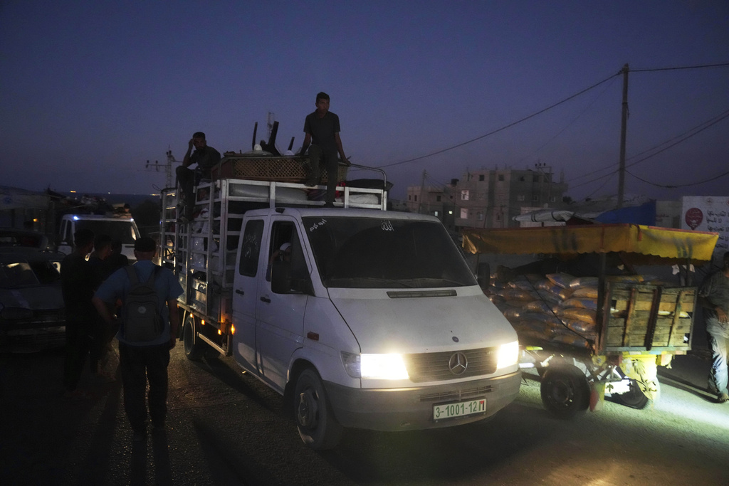 A truck transports the Abu Jarad family through Nuseirat, Gaza Strip, Sept. 10, 2025, after they were displaced from Gaza City following evacuation orders issued by the Israeli army. (AP Photo/Abdel Kareem Hana)