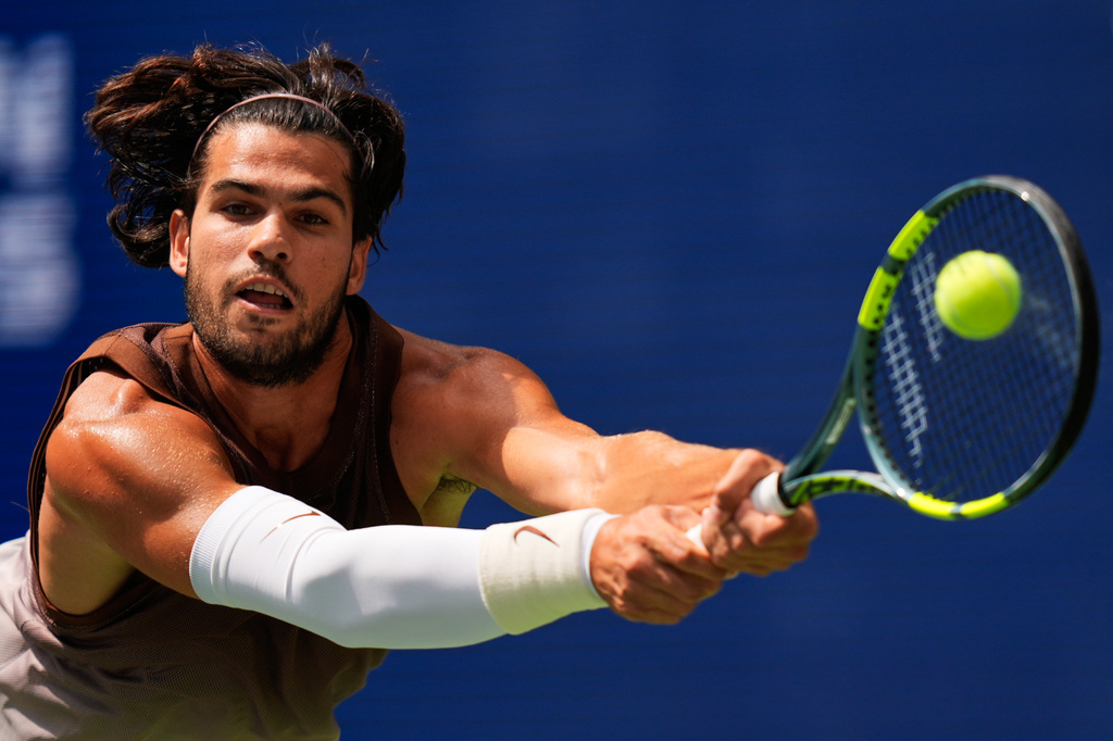 Carlos Alcaraz, of Spain, returns the ball to Roman Safiullin, of Russia, during the first round of the U.S. Open tennis championships, Monday, Aug. 31, 2026, in New York. (AP Photo/Seth Wenig)