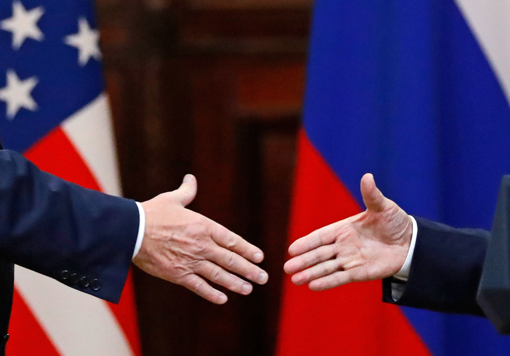 FILE - U.S. President Donald Trump shakes hand with Russian President Vladimir Putin at the end of the press conference after their meeting at the Presidential Palace in Helsinki, Finland, July 16, 2018. (AP Photo/Alexander Zemlianichenko, File)