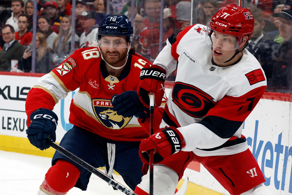 Carolina Hurricanes' Taylor Hall (71) clears the puck in front of Florida Panthers' Noah Gregor (18) during the first period of an NHL hockey game in Raleigh, N.C., Tuesday, Dec. 23, 2025. (AP Photo/Karl DeBlaker)