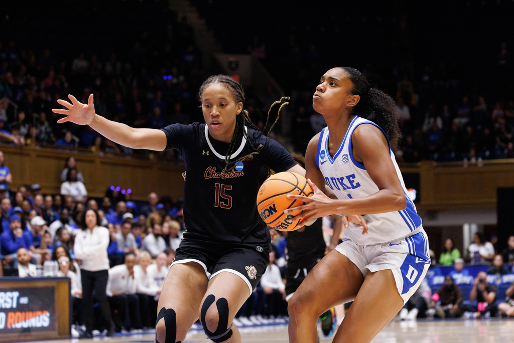 Duke's Riley Nelson, right, drives against Charleston's Tyja Beans (15) during the first half in the first round of the NCAA college basketball tournament, Friday, March 20, 2026, Durham, N.C. (AP Photo/Ben McKeown)