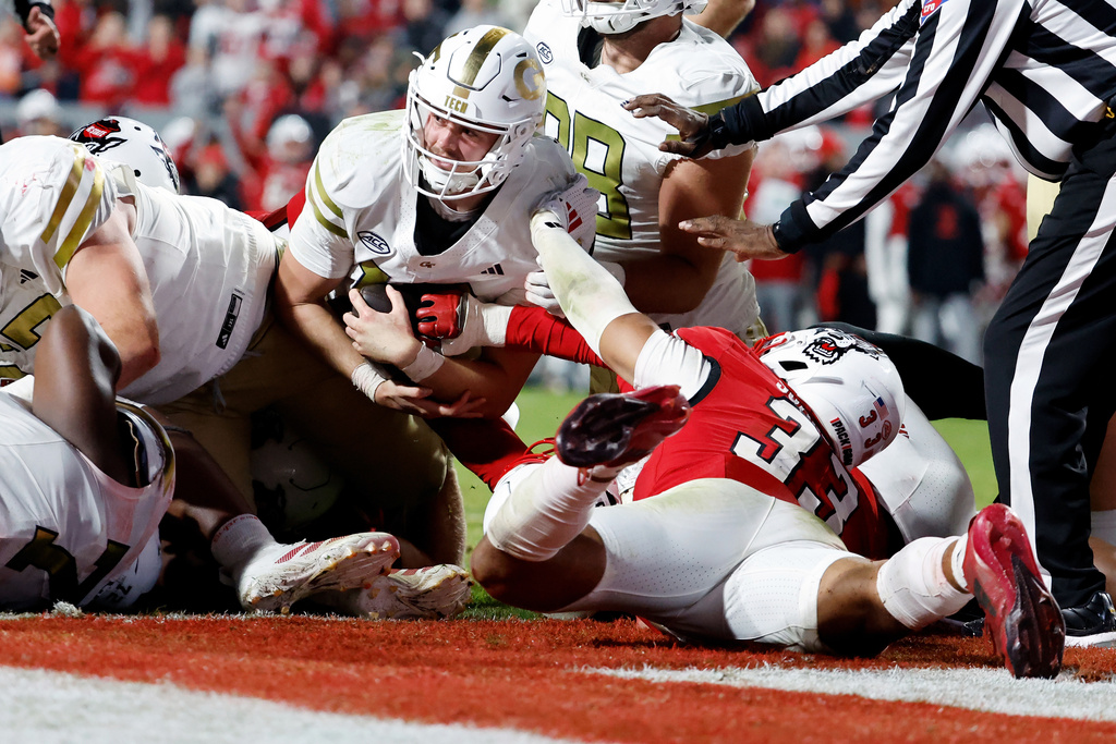 Georgia Tech quarterback Haynes King (10) is prevented from reaching the end-zone from scoring by North Carolina State linebacker Kenny Soares Jr. (33) during the second half of an NCAA college football game in Raleigh, N.C., Saturday, Nov. 1, 2025. (AP Photo/Karl DeBlaker)