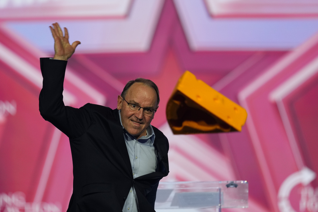 Wis. Rep. Tom Tiffany throws a cheesehead to the crowd after he spoke during Turning Point USA's AmericaFest 2025, on Saturday, Dec. 20, 2025, in Phoenix. (AP Photo/Ross D. Franklin)