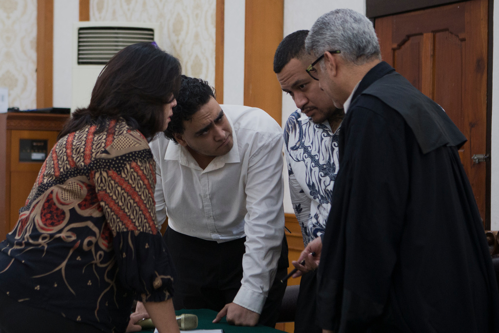 Australian nationals Paea I Middlemore Tupou, second right, and Mevlut Coskun, second left, who are on trial for the fatal shooting of an Australian tourist last year, consult with their lawyer during their sentencing hearing at the district Court, in Denpasar, Bali, Indonesia, Monday, March 9, 2026. (AP Photo/Firdia Lisnawati)