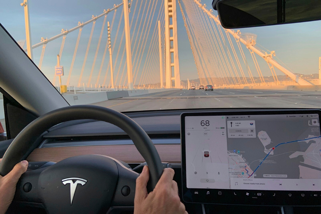 This photo provided by Edmunds shows the interior a 2020 Tesla Model Y while driving on the highway. A vehicle equipped with forward collision warning can alert a driver if the system detects that a frontal collision is likely or imminent. (Courtesy of Edmunds via AP)