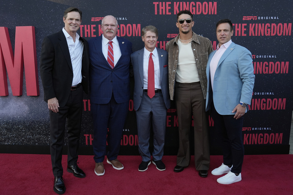Kansas City Chiefs personel from left, president Mark Donovan, head coach Andy Reid, owner Clark Hunt, quarterback Patrick Mahomes and general manager Brett Veach pose on the red carpet before a screening of the ESPN series, The Kingdom, about the Kansas City Chiefs NFL football team, Sunday, Aug. 24, 2025, in Kansas City, Mo. (AP Photo/Charlie Riedel)