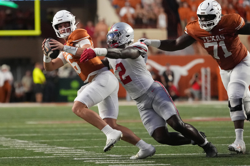 Texas quarterback Arch Manning (16) is sacked for a loss by Ohio State defensive end Kenyatta Jackson Jr. (2) during the first half of an NCAA college football game in Austin, Texas, Saturday, Sept. 12, 2026. (AP Photo/Eric Gay)