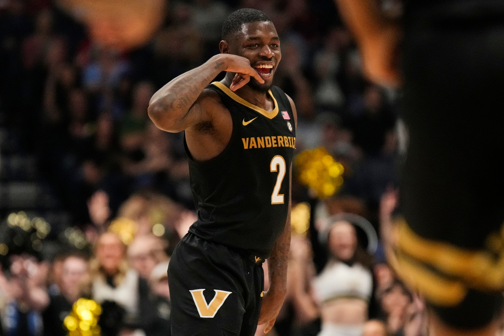 Vanderbilt guard Duke Miles (2) celebrates a three point basket during the first half of an NCAA college basketball game against Arkansas in the final of the Southeastern Conference tournament Sunday, March 15, 2026, in Nashville, Tenn. (AP Photo/George Walker IV)