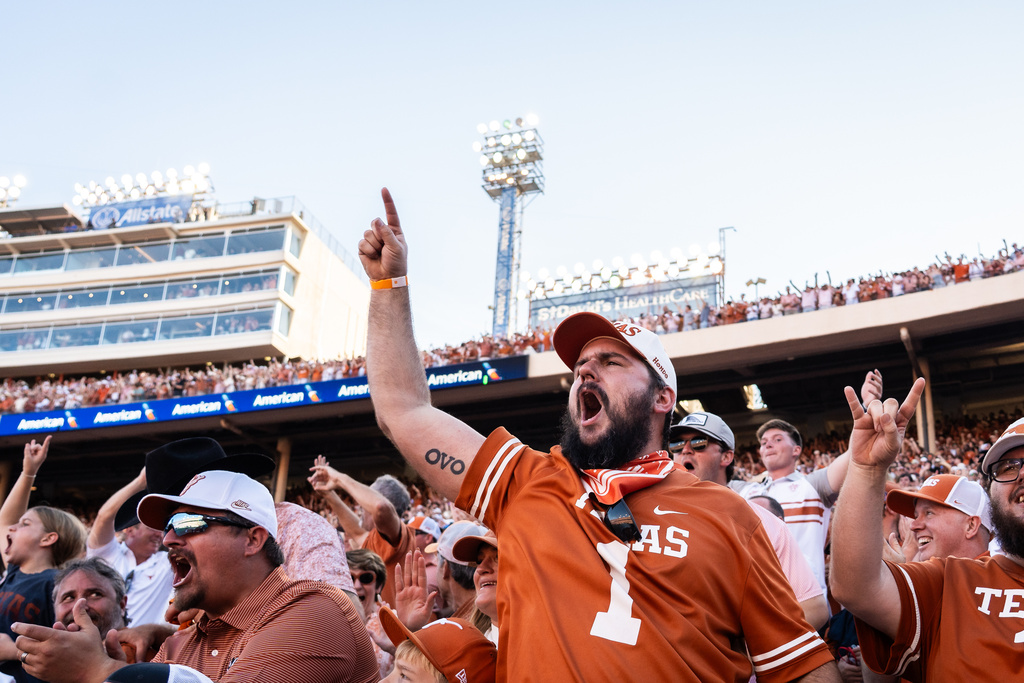 Texas fans cheer for their team in the fourth quarter of an NCAA college football game against Oklahoma at the Cotton Bowl in Dallas, Saturday, Oct. 11, 2025. (Sara Diggins/Austin American-Statesman via AP)