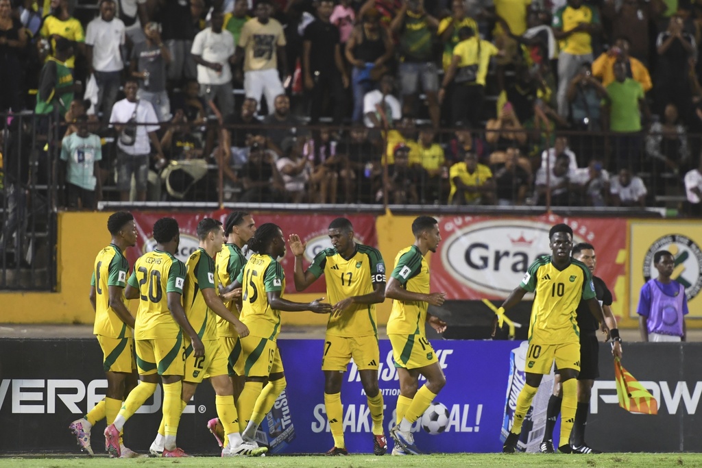 Jamaica's players celebrate their second goal against Trinidad and Tobago during a World Cup 2026 qualifying soccer match at the Independence Park stadium in Kingston, Jamaica, Tuesday, Sept. 9, 2025. (AP Photo/Collin Reid)