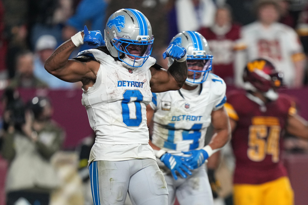 Detroit Lions running back Jahmyr Gibbs (0) celebrates after scoring during the first half of an NFL football game against the Washington Commanders Sunday, Nov. 9, 2025, in Landover, Md. (AP Photo/Stephanie Scarbrough)