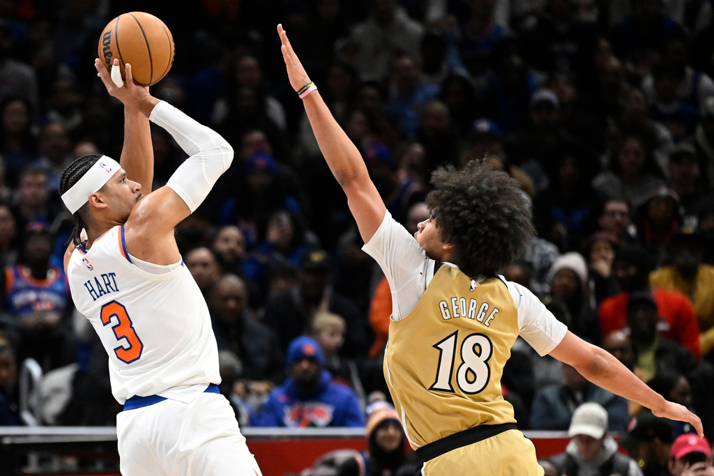 New York Knicks guard Josh Hart (3) goes to shoot against Washington Wizards forward Kyshawn George (18) during the first half of an NBA basketball game, Tuesday, Feb. 3, 2026, in Washington. (AP Photo/John McDonnell)