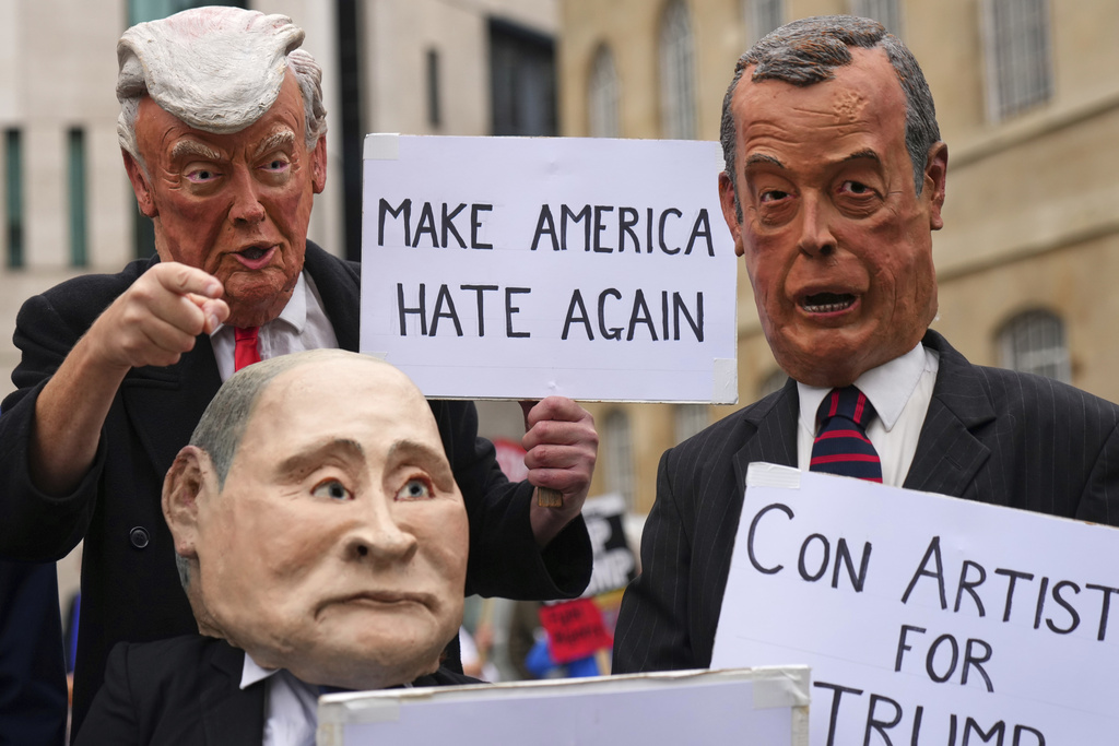 Protesters wear masks of politicians during a demonstration of the Stop Trump Coalition group against President Donald Trump's state visit in London, Wednesday, Sept. 17, 2025.(AP Photo/Joanna Chan)