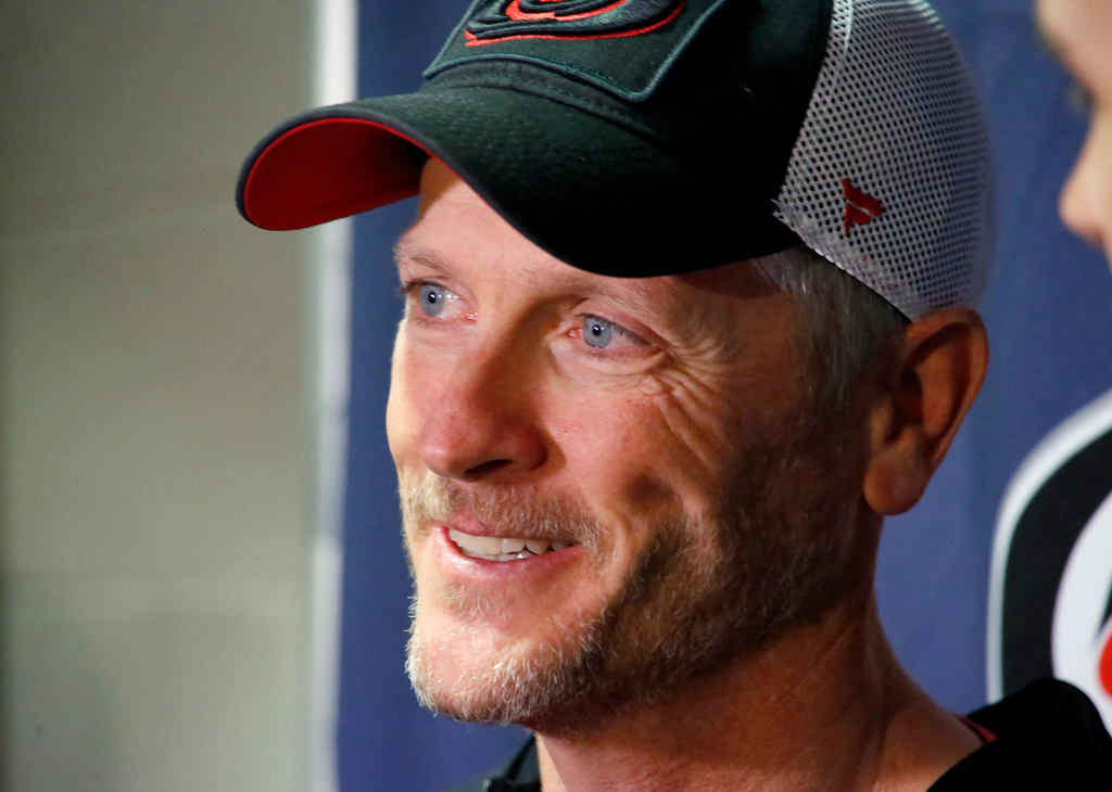 FILE - Tom Dundon, majority owner of the Carolina Hurricanes talks to the media before the start of an NHL hockey game between the New York Rangers and the Carolina Hurricanes in Raleigh, N.C., Feb. 19, 2019. (AP Photo/Chris Seward, File)