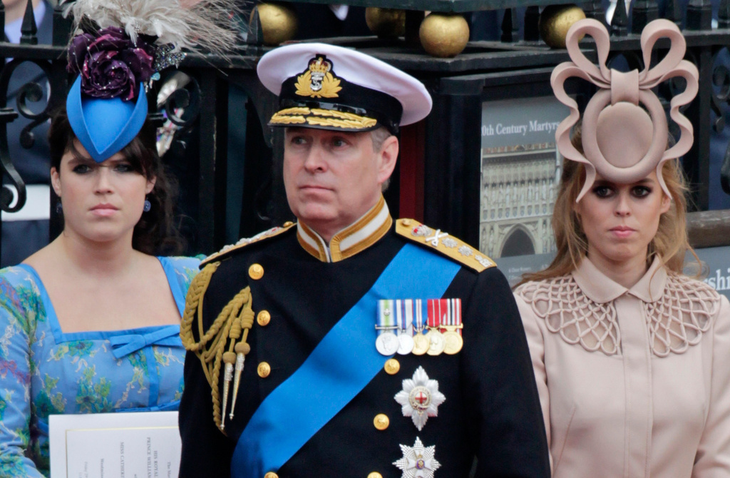 FILE - Britain's Prince Andrew, center, and his daughters Princess Eugenie, left, and Princess Beatrice leave Westminster Abbey after the wedding of Prince William to Catherine Middleton, in London, April 29, 2011. (AP Photo/Gero Breloer, File)