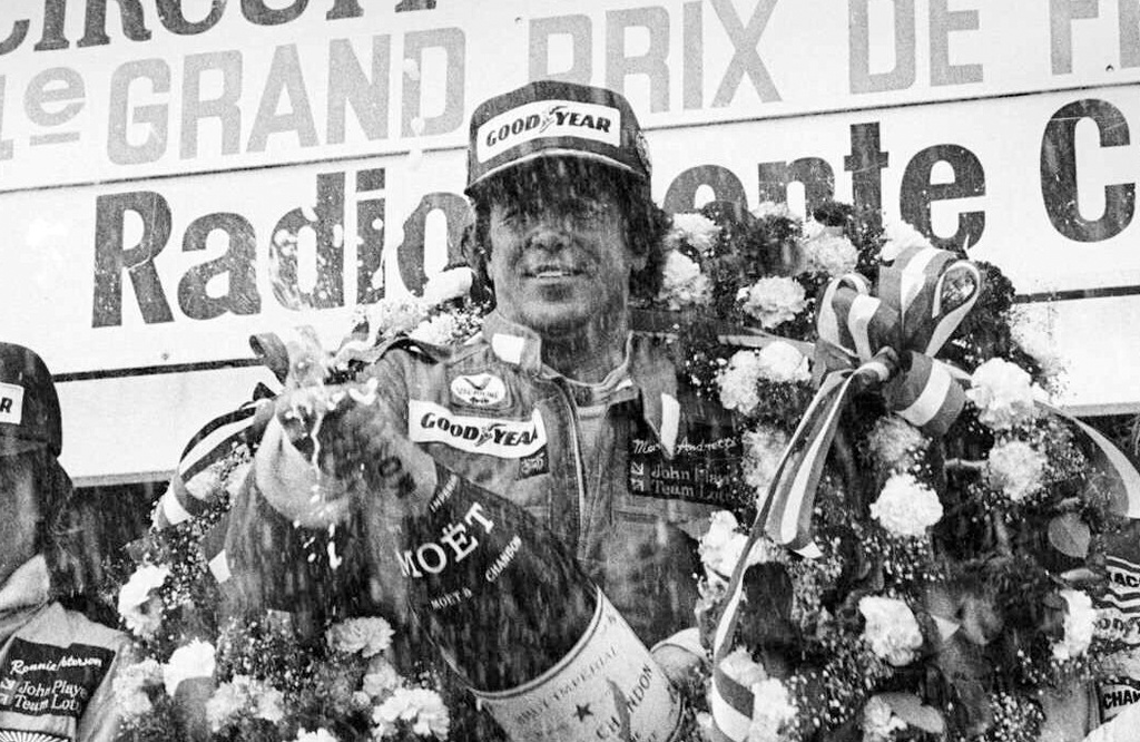 FILE - U.S. racing driver Mario Andretti showers photographers and cheering fans with a magnum of champagne after winning the Grand Prix de France auto race in a Lotus MK 1V, July 2, 1978, in Le Castellet, France. (AP Photo/Taylor Fornezza File)