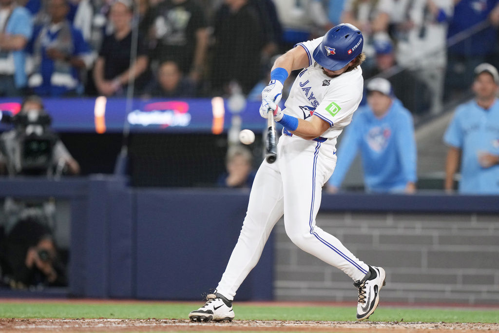 Toronto Blue Jays' Addison Barger hits a grand slam against the Los Angeles Dodgers during the sixth inning in Game 1 of baseball's World Series, Friday, Oct. 24, 2025, in Toronto. (Nathan Denette/The Canadian Press via AP)