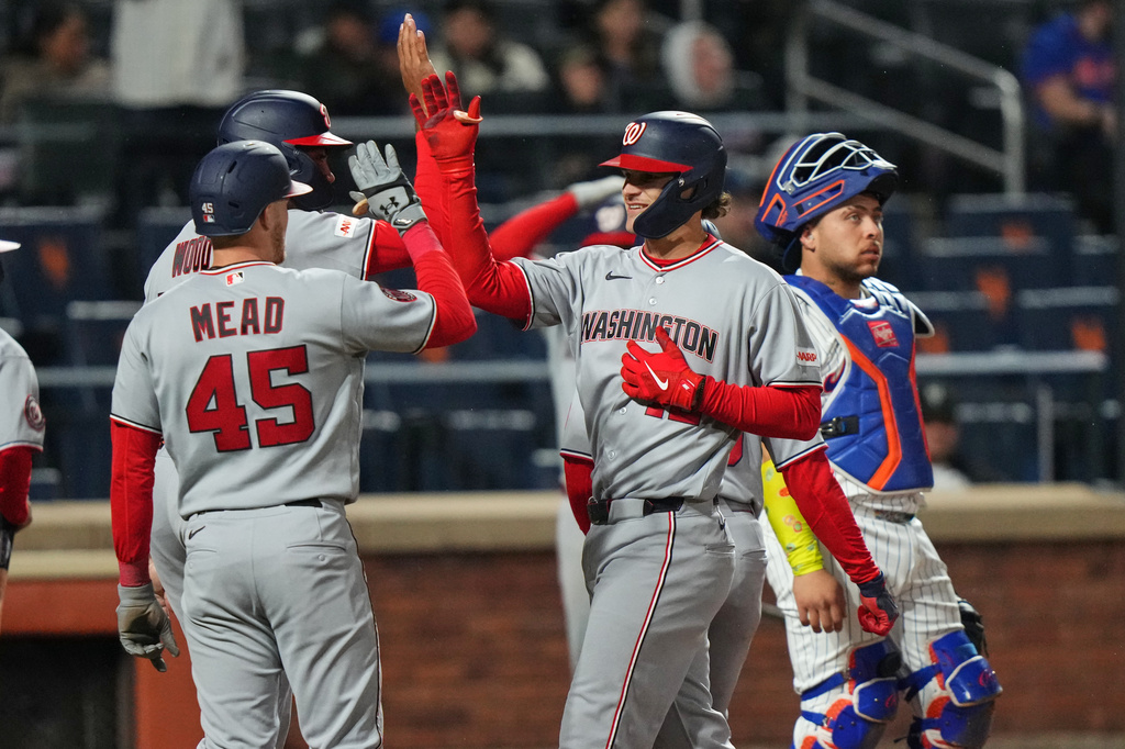 New York Mets catcher Francisco Alvarez, right, looks away as Washington Nationals' Brady House celebrates with Christian Scott, left, and James Wood after hitting a grand slam during the fourth inning of a baseball game Wednesday, April 29, 2026, in New York. (AP Photo/Frank Franklin II)