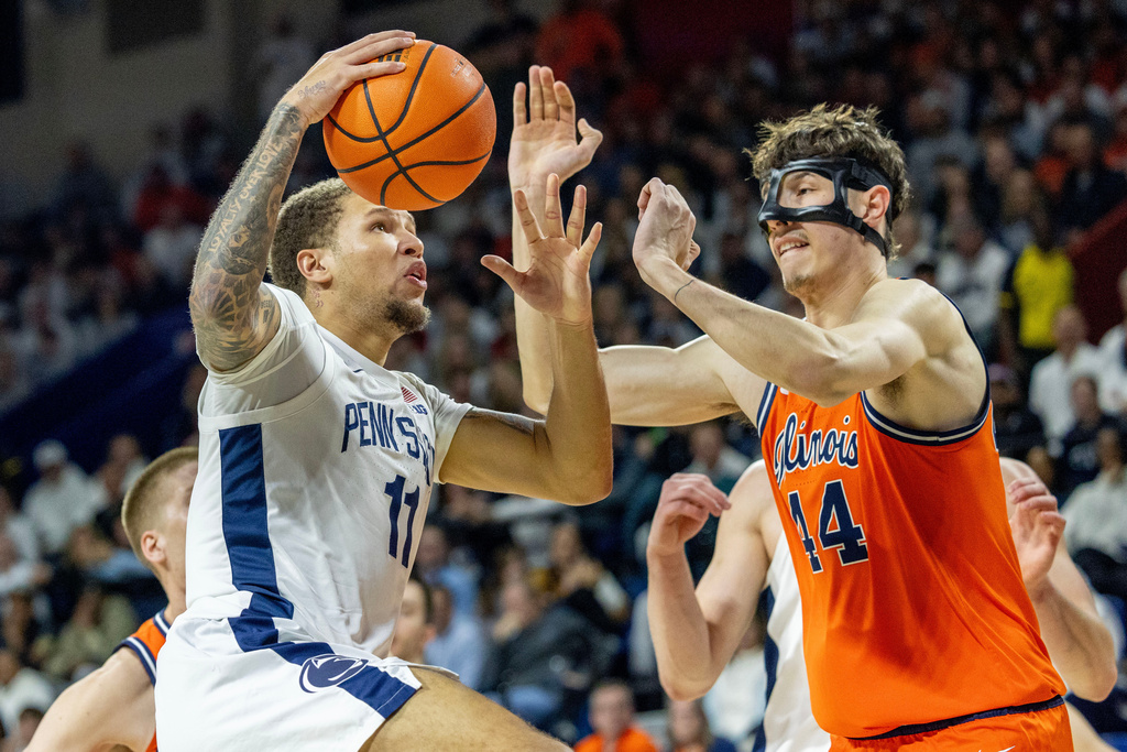 Penn State guard Eli Rice (11) takes a shot past Illinois center Zvonimir Ivisic (44) during the first half of an NCAA college basketball game, Saturday, Jan. 3, 2026, in Philadelphia. (AP Photo/Laurence Kesterson)