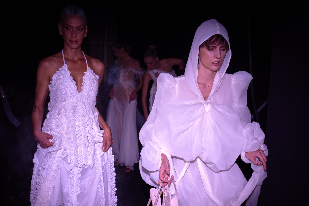 Models wear designs by De La Cierva y Nicolas backstage during the brand's show at Fashion Week in Madrid, Spain, Friday, Sept. 19, 2025. (AP Photo/Manu Fernandez)