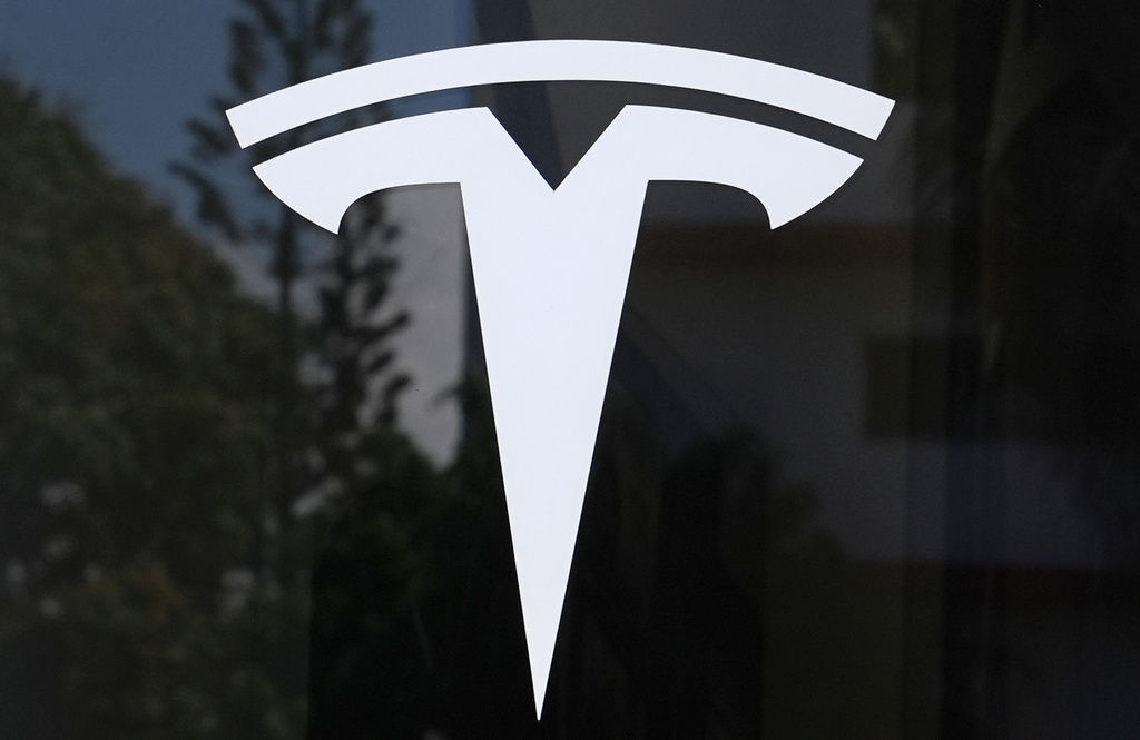 FILE - The Tesla logo is displayed at a Tesla dealership Thursday, Mar. 13, 2025, in Miami. (AP Photo/Lynne Sladky, File)