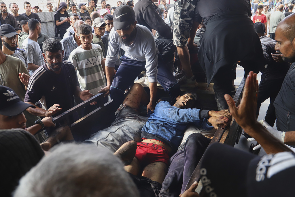 FILE - Palestinians injured in an Israeli strike are brought to Nasser Hospital in Khan Younis, southern Gaza Strip, Tuesday, June 17, 2025. (AP Photo/Mariam Dagga, File)