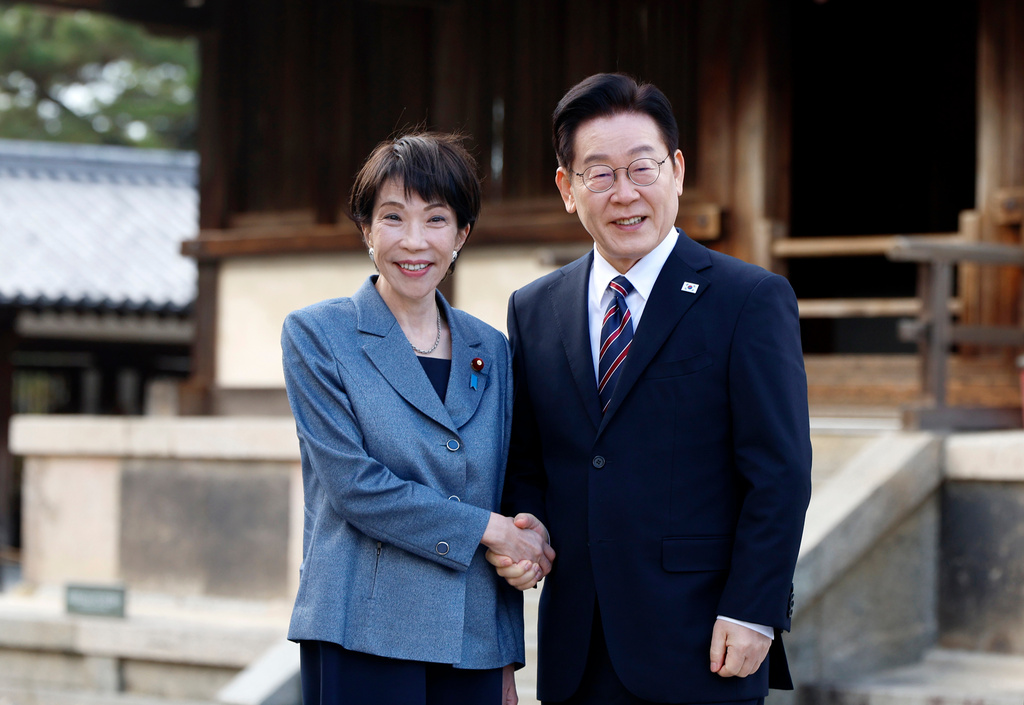 Japanese Prime Minister Sanae Takaichi, left, and South Korean President Lee Jae Myung pose for photographs as they visit the Western Precinct or Saiin Garan, at the Horyuji Temple in Ikaruga, Nara prefecture, western Japan, Wednesday, Jan. 14, 2026. (Franck Robichon/Pool Photo via AP)