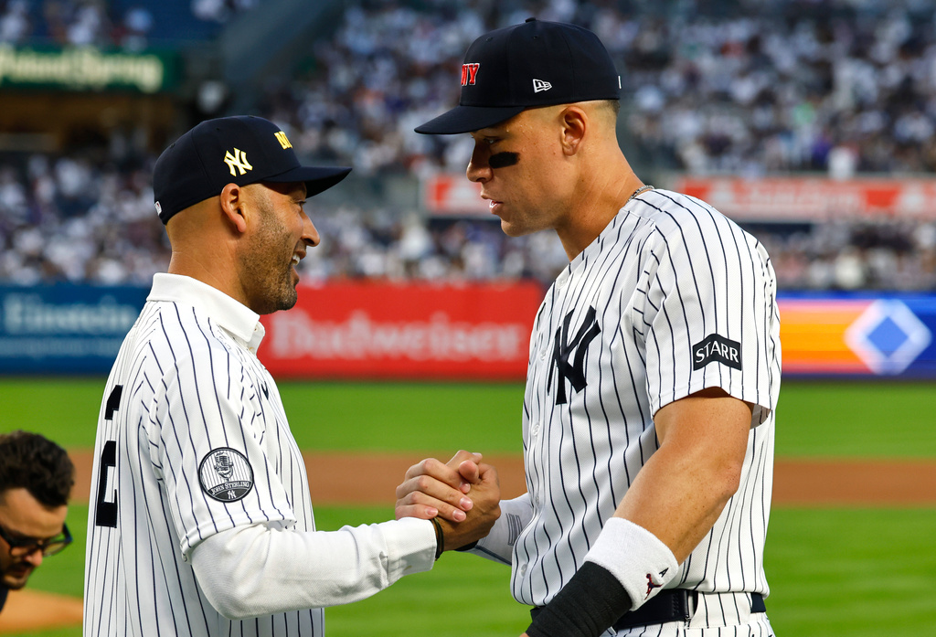 Former New York Yankee Derek Jeter shakes hands with Aaron Judge before baseball game against the New York Mets, Friday, Sept. 11, 2026, in New York. (AP Photo/Noah K. Murray)