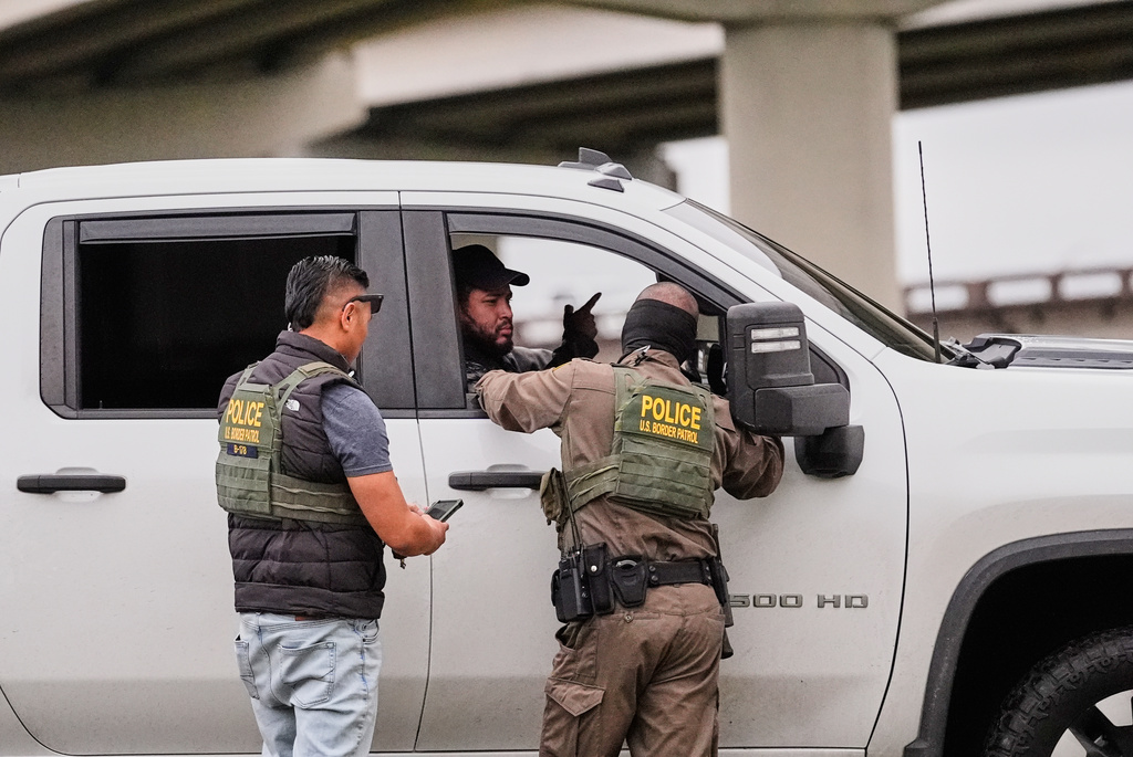 FILE - Customs and Border Patrol agents question occupants of a vehicle they pulled over, during an immigration crackdown in Kenner, La., Dec. 5, 2025. (AP Photo/Gerald Herbert, File)