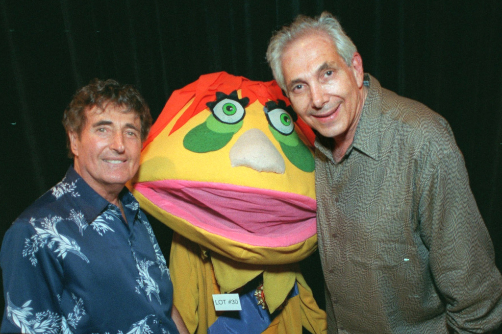 FILE - Puppeteers Sid Krofft, left, and Marty Krofft stand next to H.R. Pufnstuf, one of their many creations, at an auction in Beverly Hills, Calif., on Aug. 23, 1998. (AP Photo/John Hayes, File)