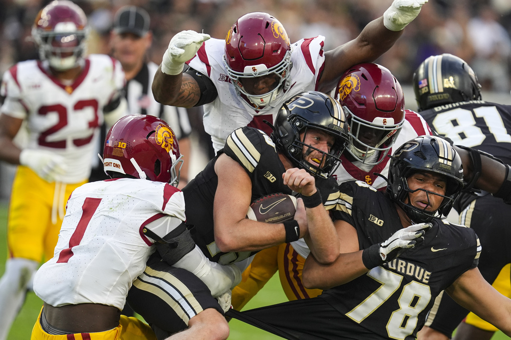 Purdue quarterback Ryan Browne (15) is tackled by Southern California defensive end Kameryn Fountain (1) during the first half of an NCAA college football game in West Lafayette, Ind., Saturday, Sept. 13, 2025. (AP Photo/Michael Conroy)