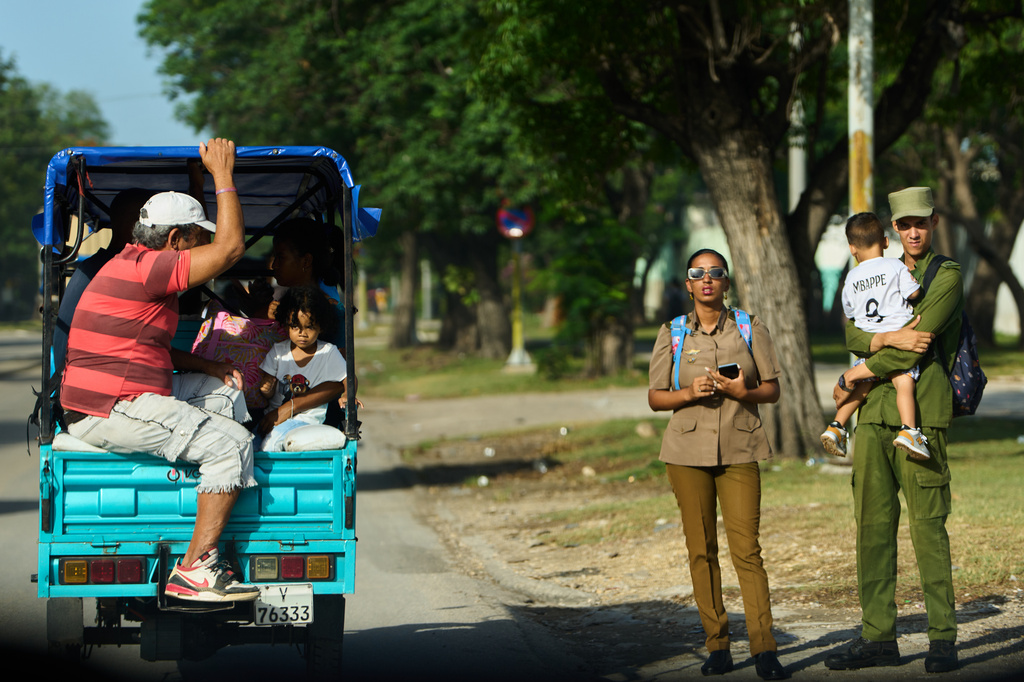 People ride in an electric tricycle in Havana, Cuba, Friday, July 10, 2026. (AP Photo/Ramon Espinosa)