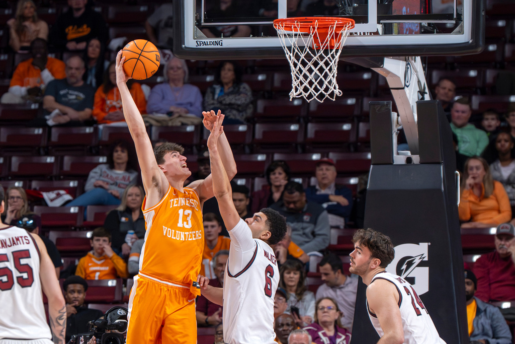 Tennessee forward J.P. Estrella (13) shoots the ball over South Carolina forward EJ Walker (6) during the first half of an NCAA college basketball game Tuesday, March 3, 2026, in Columbia, S.C. (AP Photo/David Yeazell)