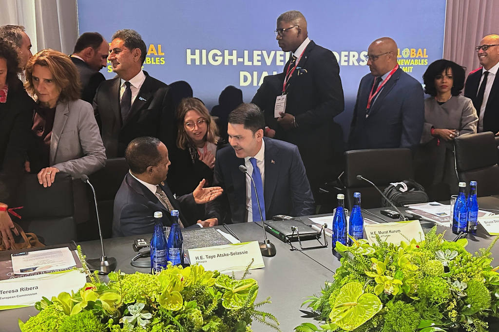 Ethiopian President Taye Atske Selassie, left, and Turkish Environment Minister Murat Kurum, who will preside over the UN climate summit in Turkey in November, right, shake hands Monday, Sept. 21, 2026, as they meet to discuss electrification at the Global Renewables Summit in New York. (AP Photo/Jennifer McDermott)